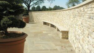 Retained cladded curved wall & freestanding pillars